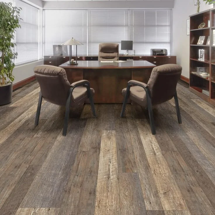 Crew installing luxury vinyl plank flooring in a commercial office space in Tampa Bay, FL